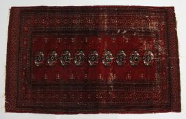 A BOKHARA RUG, red ground with a single row of nine gulls (worn). 5ft 3ins x 3ft 4ins.
