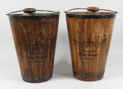 A PAIR OF WOODEN AND METAL BOUND CHAMPAGNE BUCKETS with carrying handles. 15.5ins high.