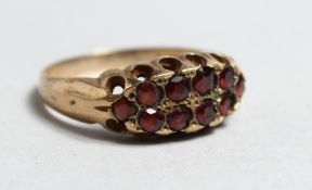 A VICTORIAN 9CT GOLD GARNET SET RING.