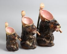 A GRADUATED SET OF THREE MAJOLICA STYLE BEAR JUGS, longest 13ins.