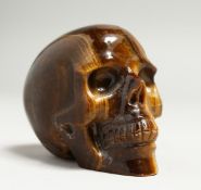 A TIGERS EYE CARVED SKULL. 8cm long.