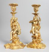 A PAIR OF GILT BRONZE CLASSICAL STYLE FIGURAL CANDLESTICKS. 11ins high.