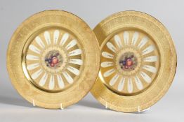 A GOOD PAIR OF AYNSLEY FRUIT PLATES with gold borders. 10ins diameter