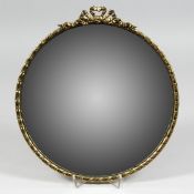 A SMALL MODERN BRASS FRAMED CONVEX MIRROR ribbon and bow cresting. 12.5ins diameter.