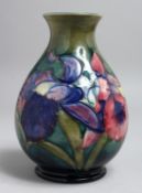 A MOORCROFT BULBOUS VASE, various flowers with Moorcroft signature and label. 7.5ins high.