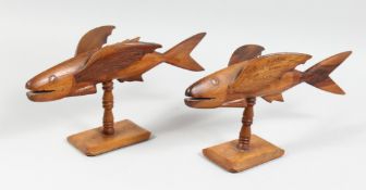 TWO PITCAIN ISLANDS CARVED WOOD MODELS OF FISH, on turned supports with platform bases, each stamped