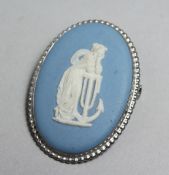 A SILVER MOUNTED WEDGWOOD JASPERWARE BROOCH, 1.75ins high.