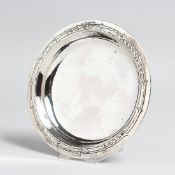 A LIBERTY & CO. SILVER CIRCULAR HAMMERED BOWL on four bun feet, 5.5ins diameter, Birmingham 1935.