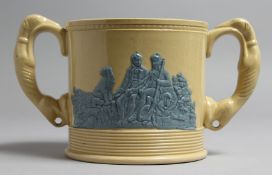 A STAFFORDSHIRE LOVING CUP with greyhound handles. 5ins high.