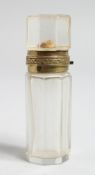 A CUT GLASS SCENT BOTTLE with hinged top, 3ins high.