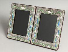 A PAIR OF SILVER AND BLUE ENAMEL PHOTOGRAPH FRAMES. 7.5ins x 5.5ins.