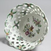 A MID 18TH CENTURY BOW SMALL BASKET with pierced sides painted with flower sprigs and sprays, in