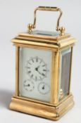 A MINIATURE BRASS CARRIAGE CLOCK with three dials, 3ins high.