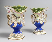 A PAIR OF COALPORT VASES with blue ground, moulded with leaves and painted with butterflies.