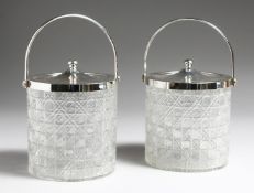 A PAIR OF CUT GLASS BISCUIT BARREL with plated mounts, 6ins high.