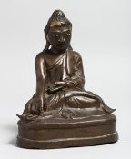 A CHINESE BRONZE SEATED BUDDHA. 6.5ins high.