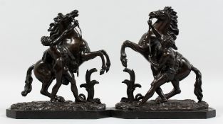A SUPERB PAIR OF BRONZE HORSES AND ATTENDANTS on marble bases. 11ins high.