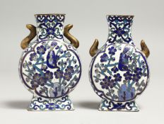 A SMALL PAIR OF CLOISONNE ENAMEL VASES, birds and foliage, 10cm high.