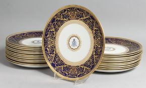 A SUPERB SET OF TWENTY THREE COALPORT PLATES with A M D crest and fine blue and gold border.