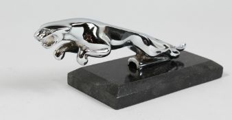 A CHROME PLATED JAGUAR CAR MASCOT on a marble base. 8ins long.