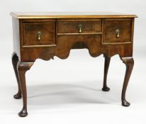 AN 18TH CENTURY WALNUT LOWBOY with a cross banded and feather banded quarter veneered top, three
