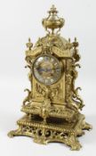 A 19TH CENTURY ORMOLU MANTLE CLOCK with eight day movement, striking on a bell, the dial with enamel