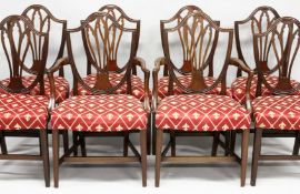 A SET OF EIGHT GEORGE III MAHOGANY DINING CHAIRS, two with arms, all with shield shaped backs,