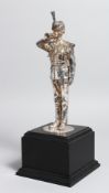 A .925 SILVER MODEL OF A STANDING BUGLER on a square base,11.5ins high overall, London hallmarks.