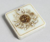 A CHINESE SQUARE SHAPE CARVED JADE PENDANT 1.75ins wide.