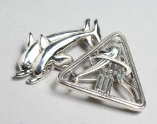 TWO SILVER JENSEN DESIGN DOLPHIN BROOCHES.