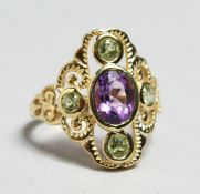 A SILVER PLATED PERIDOT AND AMETHYST RING.