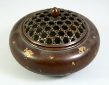 A CHINESE GOLD SPLASH BRONZE CENSER with pierced top. 4.5ins diameter.