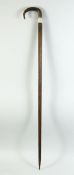 A RHINO HORN HANDLE WALKING STICK, with silver band, 98cm long.