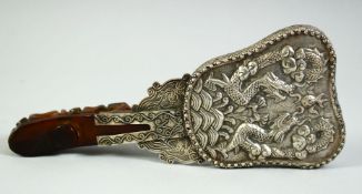 A CHINESE JADE HANDLED SILVER-METAL HAND MIRROR, the handle of traditional belt hook form, 8.8in