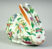 A CHINESE FAMILLE ROSE PORCELAIN RABBIT, painted with peaches and flora, 11.5cm.