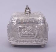 A FINE INDIAN SILVER PANDAN LIDDED BOX, the lid with baby Krishna finial, the box raised on four