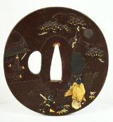 A JAPANESE BRONZE SHAKUDO TSUBA, depicting two figures in a courtyard scene beneath a tree,