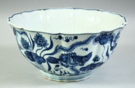 A CHINESE BLUE AND WHITE PETAL SHAPED PORCELAIN BOWL, decorated with fish, lotus and algae, the base