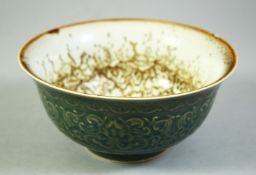 A CHINESE CELADON GLAZE PORCELAIN BOWL, the exterior with carved floral motifs, with painted blue
