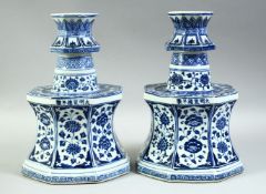 A RARE PAIR OF CHINESE BLUE AND WHITE OCTAGONAL PORCELAIN CANDLE HOLDERS, each profusely painted