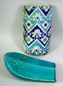 TWO ISLAMIC GLAZED RIDGE TILES, one with a turquoise glaze, the other decorated with floral