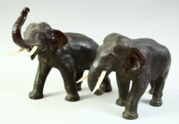 A SUPERB PAIR OF JAPANESE BRONZE ELEPHANTS, with carved ivory tusks, each with impressed seal mark