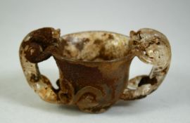 A CHINESE CUT GLASS TWIN HANDLE LIBATION CUP, 10cm wide.