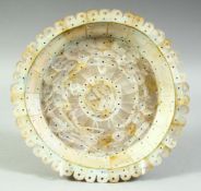 AN INDIAN GOA MOTHER OF PEARL DISH, made entirely of cut pieces of mother of pearl, 19cm diameter.