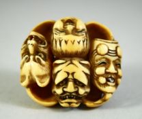 A JAPANESE CARVED IVORY NETSUKE, carved as a roundel of noh masks, discreetly signed inside, 4cm.