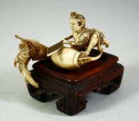 A SMALL JAPANESE CARVED IVORY OKIMONO, of male figure with a giant radish, together with an