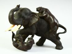 A JAPANESE MEIJI PERIOD BRONZE GROUP OF A BULL ELEPHANT being attached by two tigers, with impressed