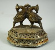 A 19TH CENTURY INDIAN BRASS FOOT SCRAPER, with finial formed as birds, 8.5cm wide.