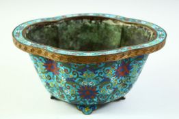 A CHINESE CLOISONNE QUATREFOIL SHAPE PLANTER, with cloisonne floral motif decoration and raised on