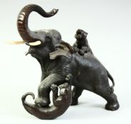 A JAPANESE MEIJI PERIOD BRONZE GROUP OF A BULL ELEPHANT being attached by two tigers, with impressed